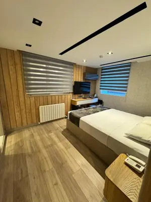 a bedroom with a large bed and a desk at Mateo in Istanbul