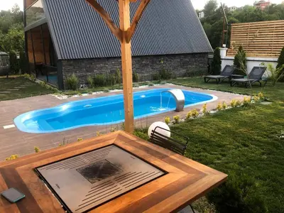 a swimming pool in the yard of a house at 7Sense Nature Resort in Sapanca