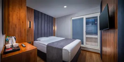 a hotel room with a bed and a window at Elite Port Hotel Istanbul Airport in Arnavutköy