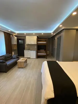 a hotel room with a bed and a living room at Sahra Kent Otel Kadıköy in Istanbul