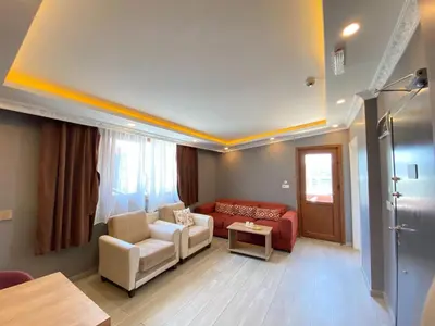 a living room with a couch and a table at Sahra Kent Otel Kadıköy in Istanbul