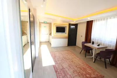 a hotel room with a table and a television at Sahra Kent Otel Kadıköy in Istanbul