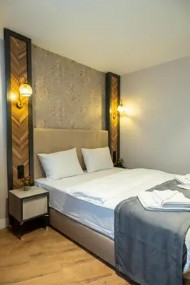 a hotel room with two beds with white sheets at Linda Port Hotel in Istanbul