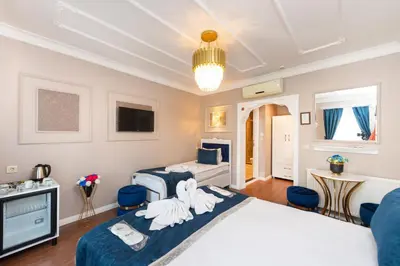 a bedroom with two swans on the bed at Begonville Corner in Istanbul