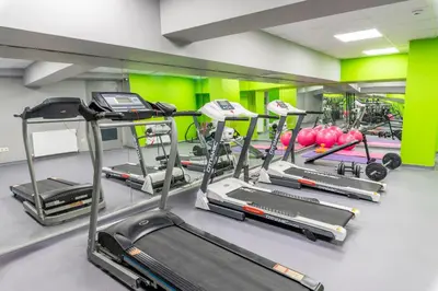 a gym with several treadmills and exercise bikes at The Royal Luxury Hotels in Istanbul