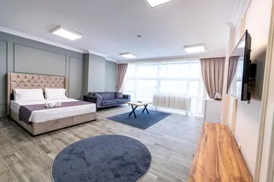 a bedroom with a bed and a tv and a couch at The Royal Luxury Hotels in Istanbul