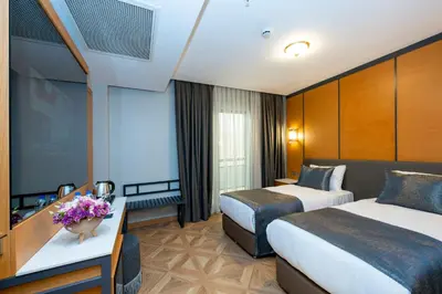 a hotel room with two beds and a television at Freya Hotel in Istanbul