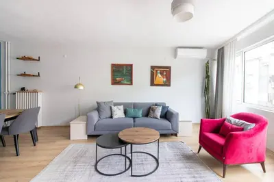 a living room with a couch and a table and chairs at 2BR Bright Kadıköy Apartment & AC in Every Room in Istanbul