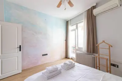 a bedroom with a white bed with towels on it at 2BR Bright Kadıköy Apartment & AC in Every Room in Istanbul