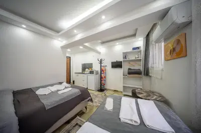 a room with two beds and a sink in it at Amida Family apart in Istanbul