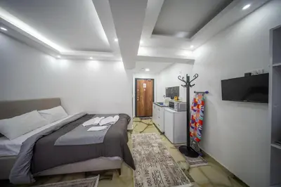 a bedroom with a bed and a flat screen tv at Amida Family apart in Istanbul