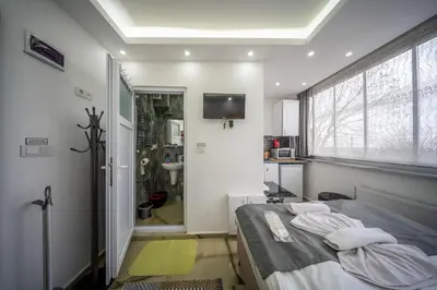 a bedroom with a bed and a bathroom with a television at Amida Family apart in Istanbul