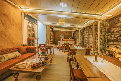 a living room with a couch and tables at Blu Macel Hotel & Suites -Old City Sultanahmet in Istanbul