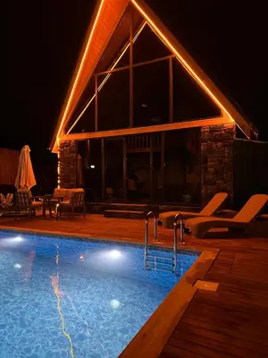 a swimming pool in front of a building at night at ROSE SAPANCA STONE HOUSE in Sakarya