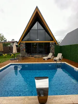a swimming pool in front of a house at ROSE SAPANCA STONE HOUSE in Sakarya