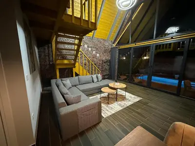 a living room with a couch and a table at ROSE SAPANCA STONE HOUSE in Sakarya