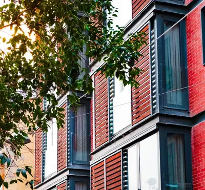 a red and white brick building with windows at Homie Suites - ''Loft 27'' Urban Comfort Suites in the Heart of Cihangir in Istanbul