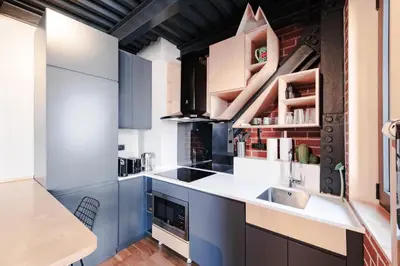 a kitchen with blue cabinets and a sink at Homie Suites - ''Loft 27'' Urban Comfort Suites in the Heart of Cihangir in Istanbul