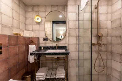 a bathroom with a sink and a mirror at Khai Karaköy in Istanbul