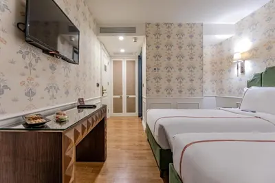 a hotel room with two beds and a table at Khai Karaköy in Istanbul