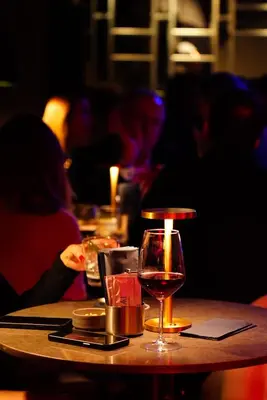 a table with a glass of wine on it at Khai Karaköy in Istanbul