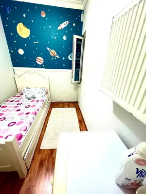 a small room with a bed and a space mural at Best house for family in Istanbul
