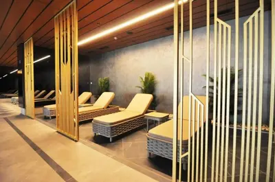 a waiting area with chairs and tables in a building at Gorgeous Corner Deluxe 1BD CondoPoolViews! #133 in Istanbul