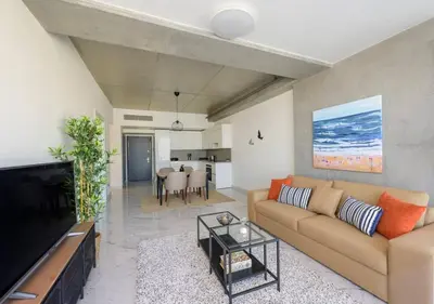 a living room with a couch and a table at Bright Lovely Deluxe 1BD CondoPoolViews! #134 in Istanbul