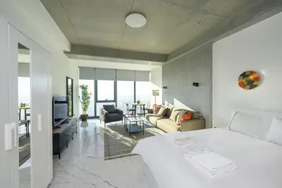 a bedroom with a bed and a living room at Gorgeous Bright Studio Parking PoolViews! #135 in Istanbul
