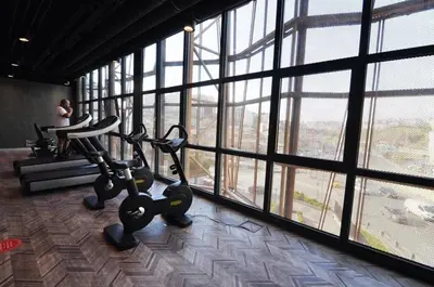 a gym with a large window with exercise bikes at Gorgeous Bright Studio Parking PoolViews! #135 in Istanbul