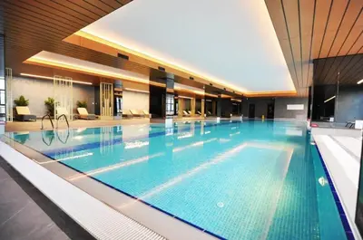 a large swimming pool in a hotel with a large pool at Gorgeous Bright Studio Parking PoolViews! #135 in Istanbul