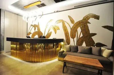 a living room with a couch and a wall with plants at Bright Lovely Modern 2BD25 Condo PoolGym! #220 in Istanbul