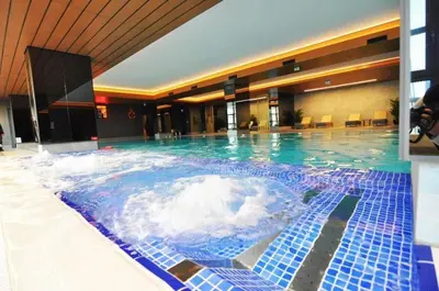 a large pool of water in a hotel at Beautiful Modern 1BD Condo Views w PoolGym! #223 in Istanbul