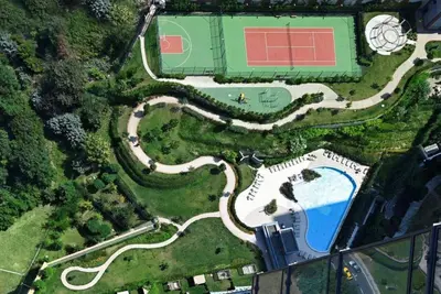 an overhead view of a tennis court and a pool at Lovely Modern 1BD Condo Views w PoolGym! #222 in Istanbul