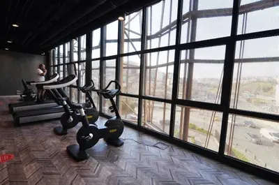 a gym with two exercise bikes in a room with windows at Lovely Modern 1BD Condo Views w PoolGym! #222 in Istanbul