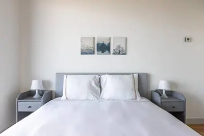 a bedroom with a white bed with two night stands at Gorgeous Modern 1BD Terrace CondoPoolViews! #233 in Istanbul