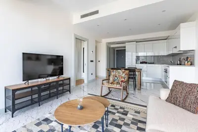 a living room with a couch and a table at Gorgeous Modern 1BD Terrace CondoPoolViews! #233 in Istanbul