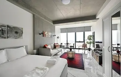 a bedroom with a bed and a living room at Gorgeous Bright Studio w Parking PoolViews! #236 in Istanbul