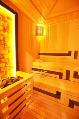 a sauna with a bench and a tub in it at Gorgeous Bright Studio w Parking PoolViews! #236 in Istanbul