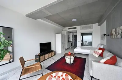 a living room with a couch and a table at Gorgeous Bright Studio w Parking PoolViews! #236 in Istanbul