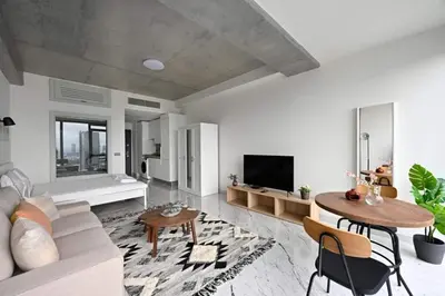 a living room with a couch and a table at Cozy Bright Studio w Parking, PoolViews! #237 in Istanbul