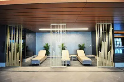 a lobby with white chairs in a building at Cool Bright Studio w Parking PoolViews! #238 in Istanbul