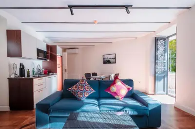a living room with a blue couch with pillows on it at Homie Suites - Turna Residences in Cihangir in Istanbul