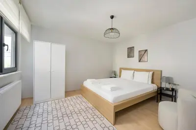 a white bedroom with a bed and a window at Modern Prime Location 2BD1Bath Cozy Home! #213 in Istanbul