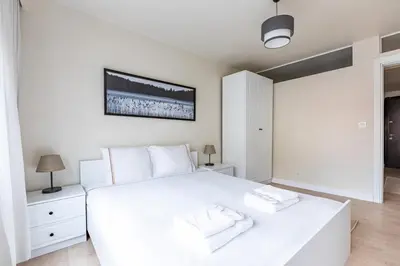 a white bedroom with a large white bed with two towels at Modern Prime Location 1Bed Bright Home! #243 in Istanbul