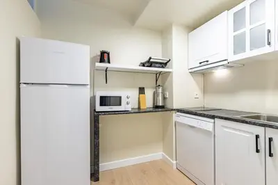 a kitchen with white cabinets and a white refrigerator at Modern Prime Location 1Bed Bright Home! #243 in Istanbul