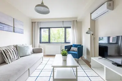 a living room with a couch and a tv at Modern Prime Location 1Bed Bright Home! #243 in Istanbul