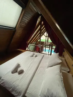 a bed with towels on it in a room with a window at MİNNA BUTİK EV in Sapanca