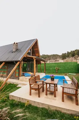 a patio with chairs and a table and a house at MİNNA BUTİK EV in Sapanca