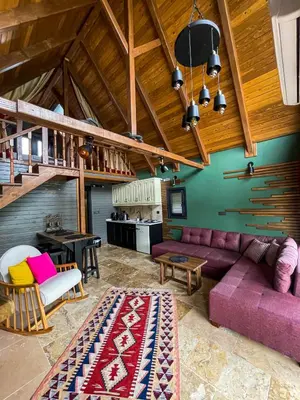 a living room with a purple couch and a table at MİNNA BUTİK EV in Sapanca